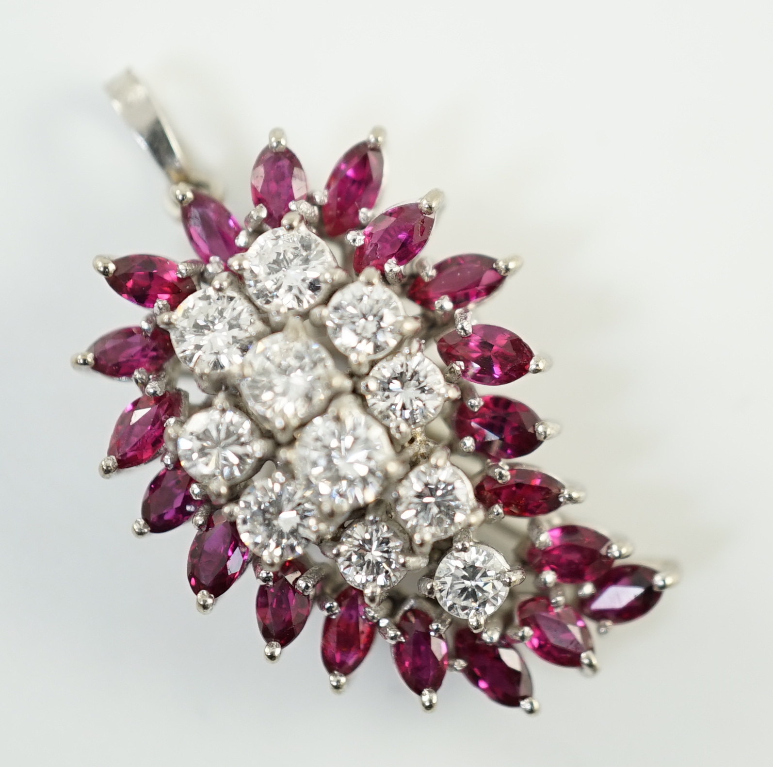 A modern white gold, ruby and diamond set pear shaped cluster pendant